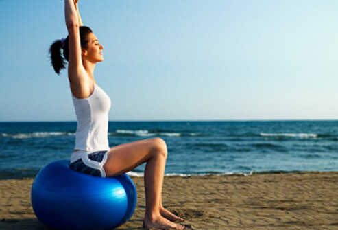 Top 10 fitness facts s3 photo of woman on exercise ball at beach