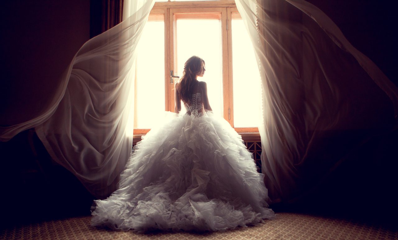 bride looking trough window