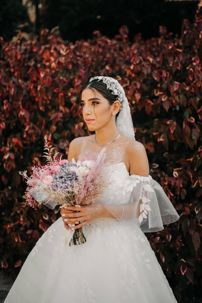 bride holding pink bouquet
