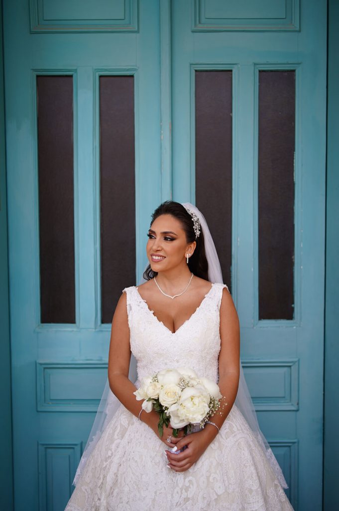 bride in front of blue door