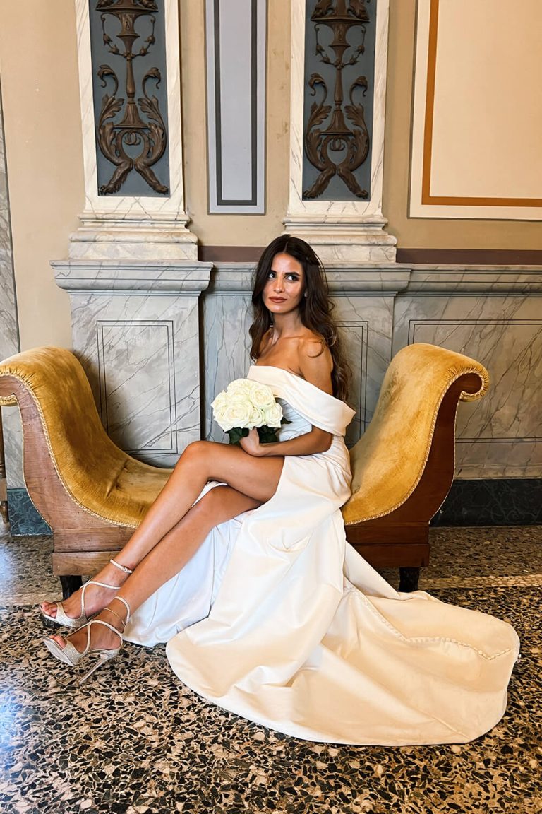 bride sitting on chair wearing wedding dress