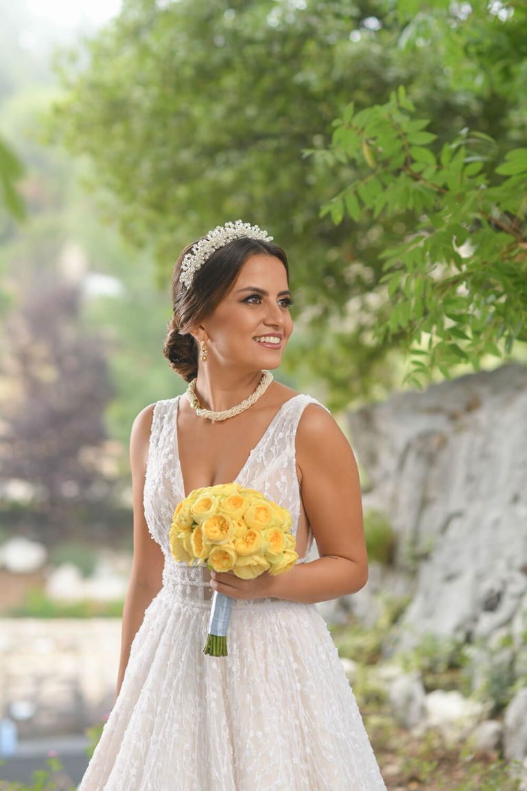 Bride holding yellow flowers