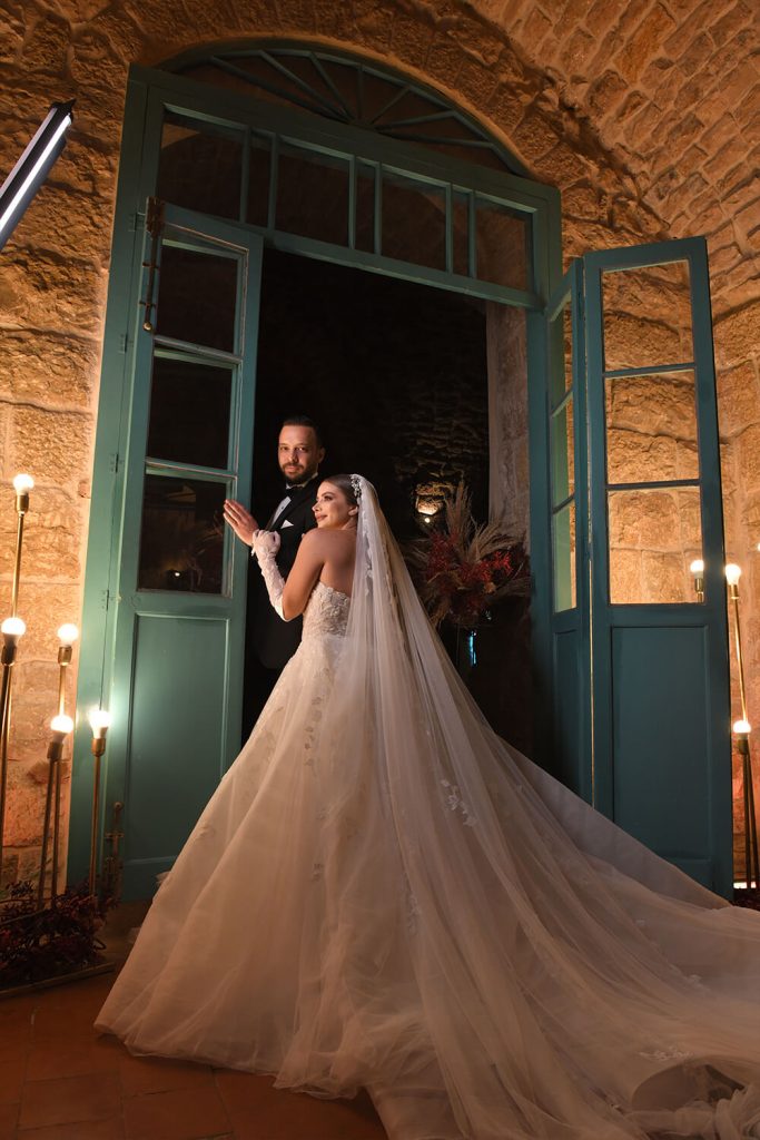 Bride and groom next to blue door